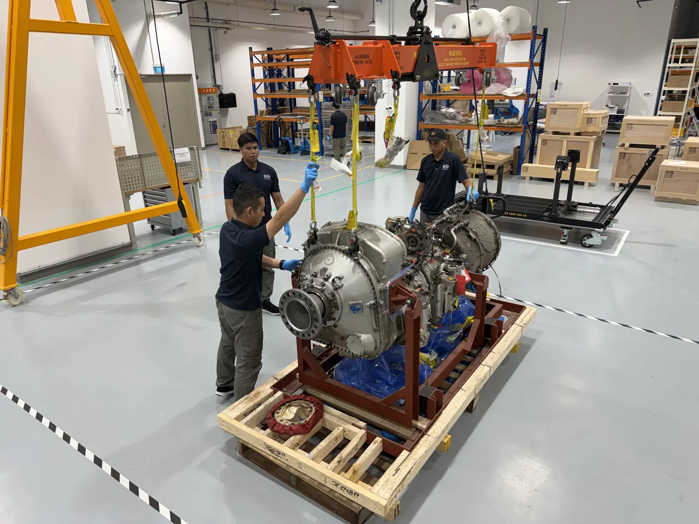 BIAero technicians lowering a turboprop engine onto its crate at the Singapore facility