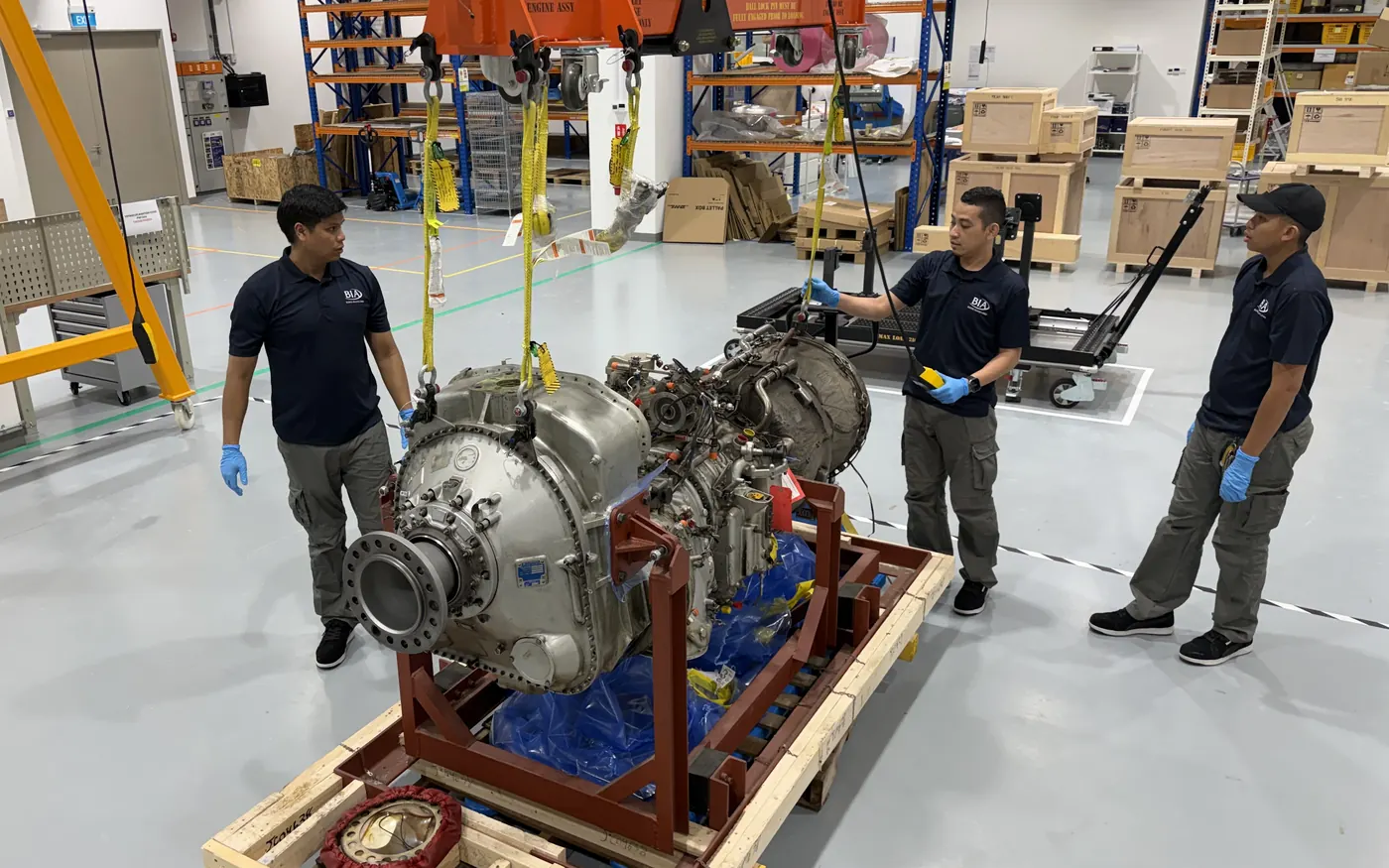 BIAero technicians lowering an engine onto its shipping crate
