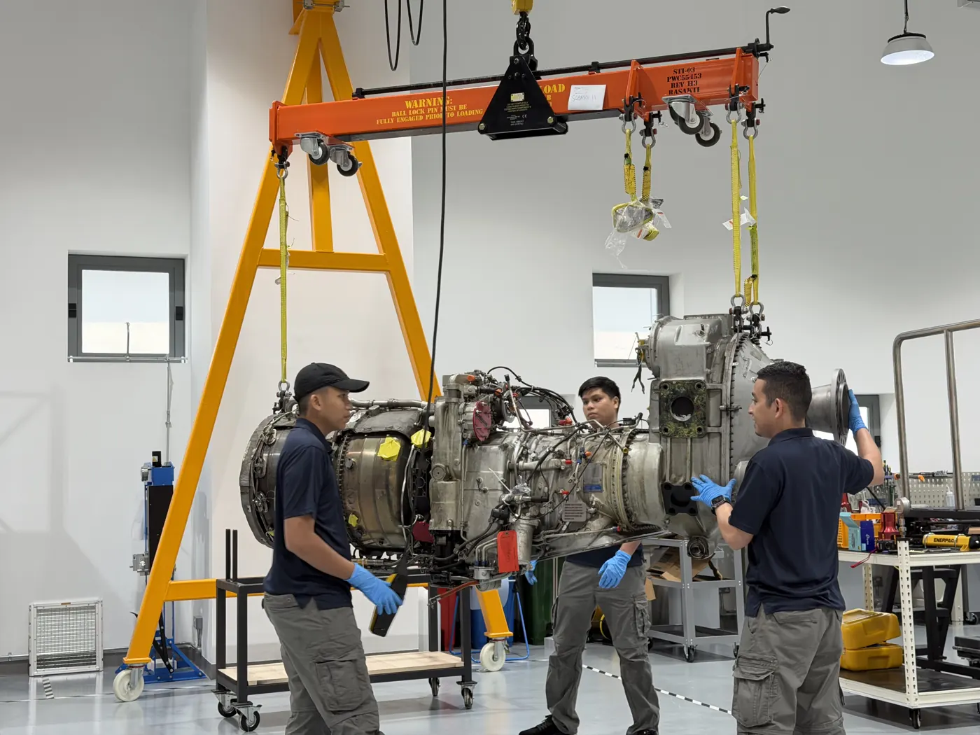 BIAero technicians moving a turboprop engine on the gantry hoist in Singapore