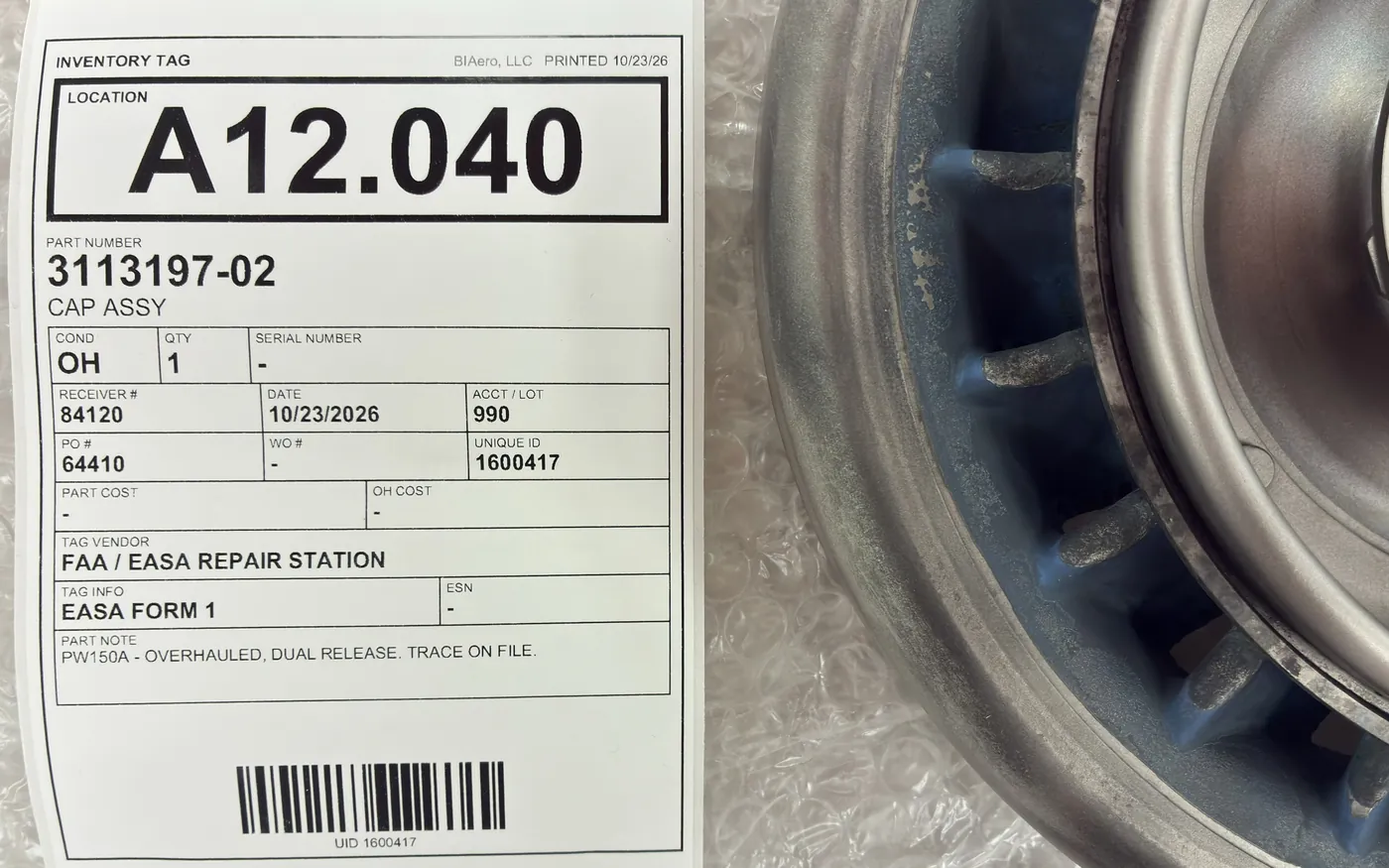 A BIAero inventory tag with location, part number and condition beside an overhauled engine component